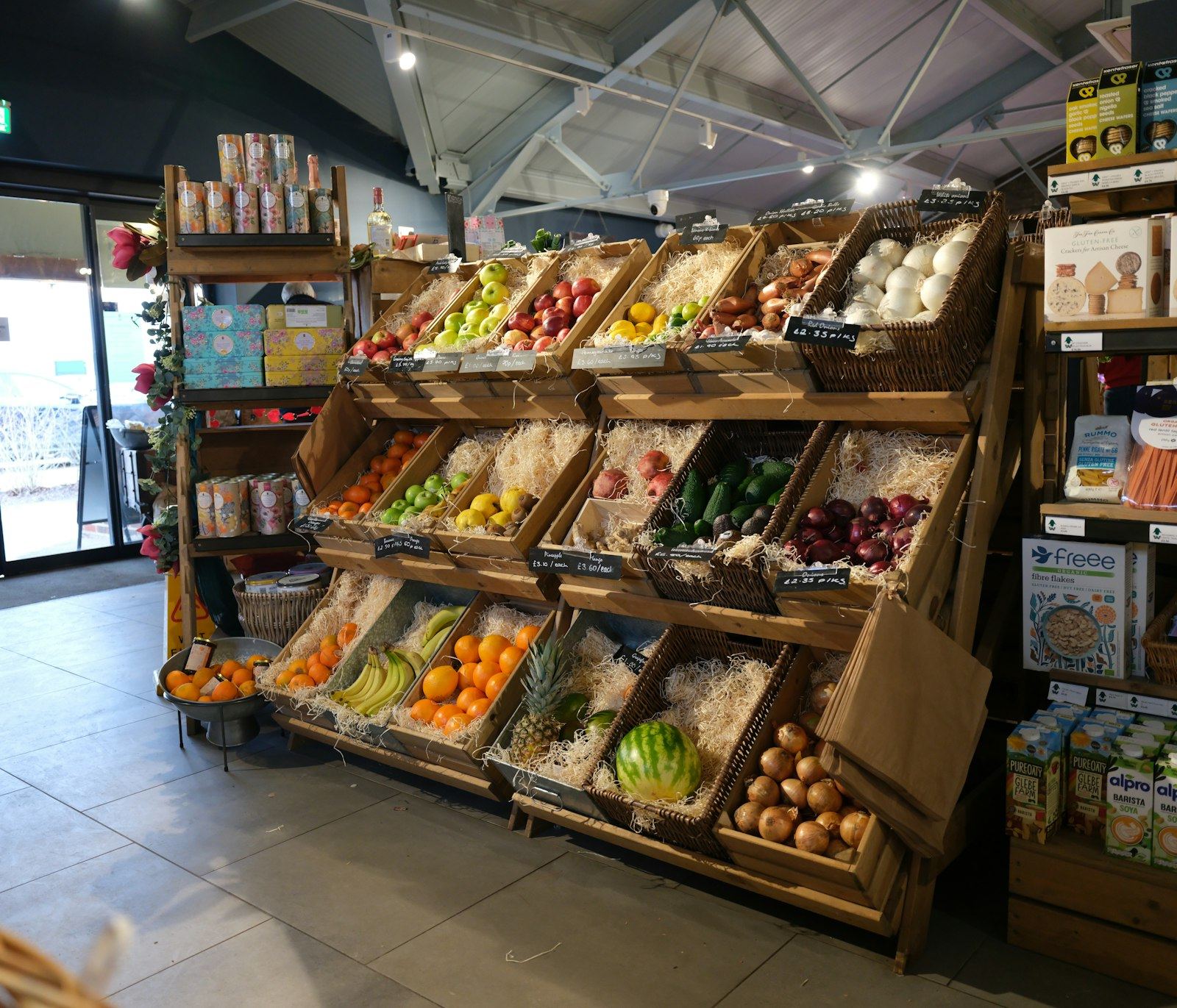 A farm shop with wooden crates of fresh produce