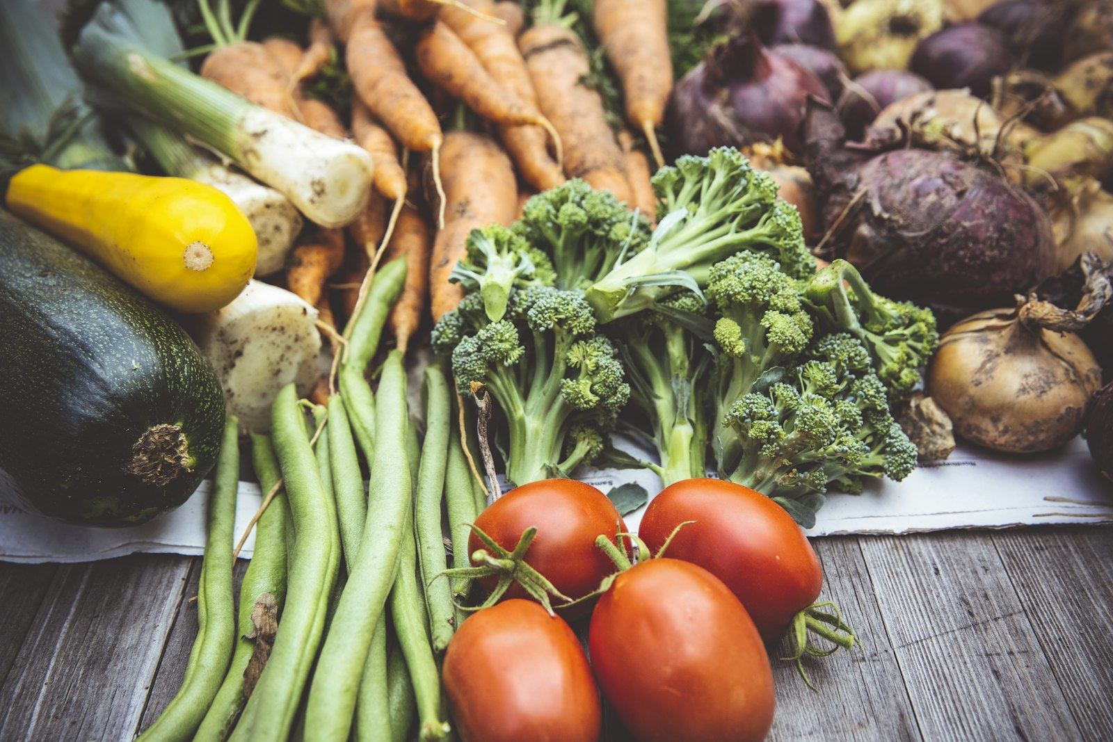 Fresh vegetables laid out on a wooden table